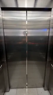 First-person view inside an elevator, watching the doors close, then frantically pressing the open button as a woman approaches in the hallway.
