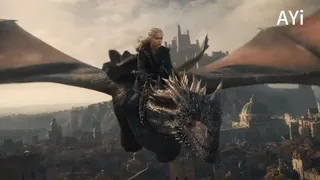 Drogon, the dragon, unleashes a torrent of fire while flying low and fast over the rooftops of King's Landing, with Daenerys on its back, in a dramatic, cinematic scene.