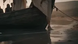Cinematic wide shot of a couple on a sailboat at sunrise, then offering compassion to a chained man in a desert, and finally reading a book together.