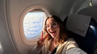 A traveler taking a selfie with a famous world landmark in the background, with a fast-paced montage effect.