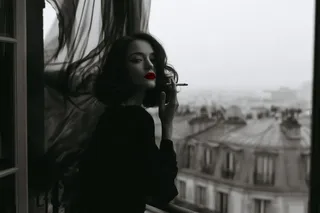 Minimalist vintage French noir photography with high-contrast monochrome and a single vivid red detail.