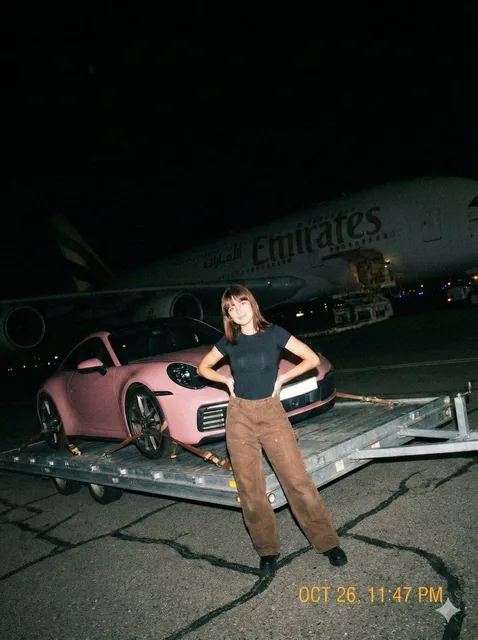 A gritty, handheld iPhone photo taken at night on an airport tarmac with harsh direct on-camera flash. Imperfect, slight