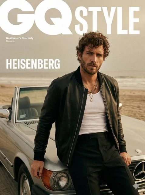 A cinematic fashion editorial portrait of male model for a GQ Style magazine cover. He is leaning against the hood of a