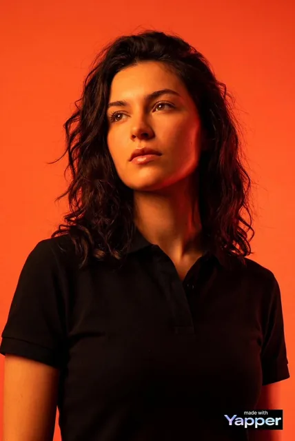 Create a high-impact editorial studio portrait using the person from the attached reference photo as the only identity s