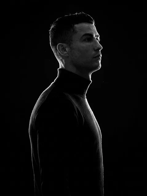 A minimalist black and white cinematic portrait featuring two individuals (male and female) in strict side profile, both