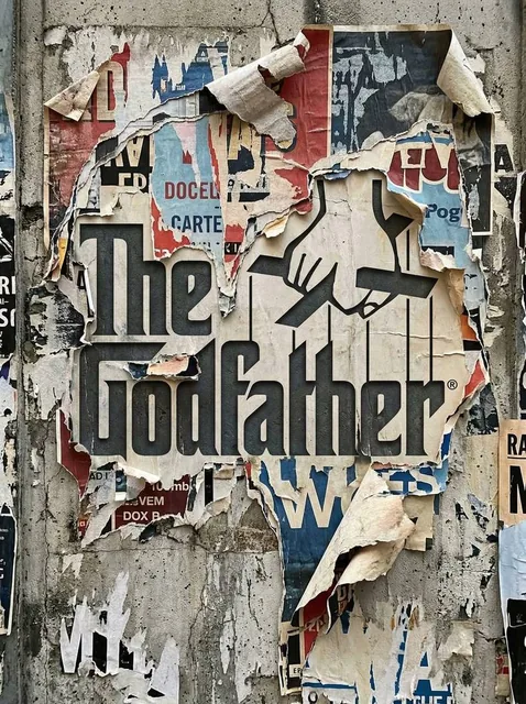 Transform the uploaded logo into a realistic urban wall scene where the logo silhouette is revealed through layers of to