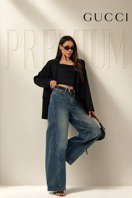 full body female model in confident fashion pose (one leg slightly raised, relaxed luxury stance), wearing oversized bla