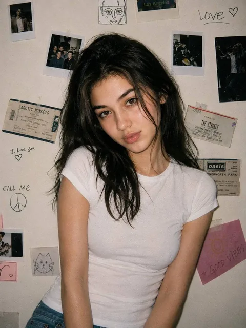 A young woman with the same unchanged face, pale soft complexion, caught in a classic 90s disposable-camera snapshot. He