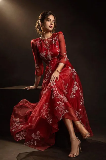 Ultra-realistic high-fashion Vogue magazine editorial portrait of a beautiful young woman wearing an elegant deep ruby-r