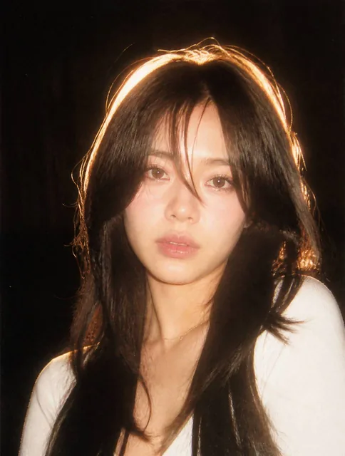 A nostalgic 90s film photography style portrait. Harsh direct camera flash lighting, strong contrast, subtle film grain