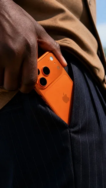 A close-up shot shows a person's dark-skinned hand, likely belonging to a Black male of indeterminate age, as it tucks a