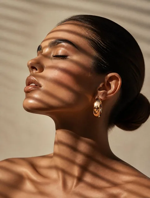 Close-up portrait of a woman showing only her head and shoulders, in profile, head tilted slightly back, eyes closed, sl