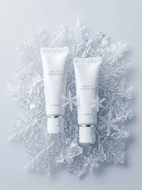 A perfect advertising photograph, an intricate composition. Two tubes rest on rough ice floes. The white background tran