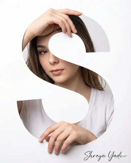 DSLR-style portrait of a person's face and hands realistically appearing through a cutout shaped like the letter 'S', against a plain white background with soft studio lighting.