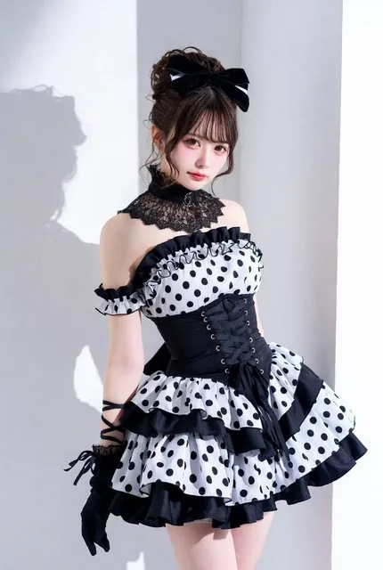 A young Japanese woman dressed in classic Gothic Lolita fashion, wearing a monochrome polka dot dress with matching accessories, set against a stylish background.