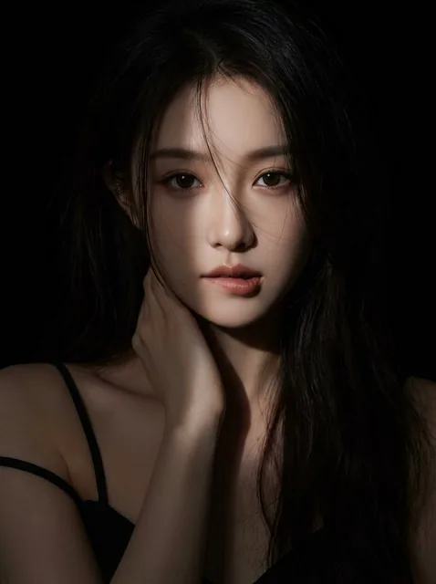 A hyperrealistic female portrait with a narrow beam spotlight sharply focused on the face, creating dramatic high-contrast lighting against a completely black background, featuring long dark hair and a sultry expression.