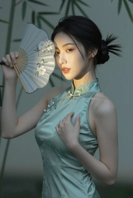 A female portrait in a new Chinese pure desire style, featuring a woman with a classical hairstyle and a translucent fan partially covering her face, set against a blurred green background with soft lighting and warm tones.