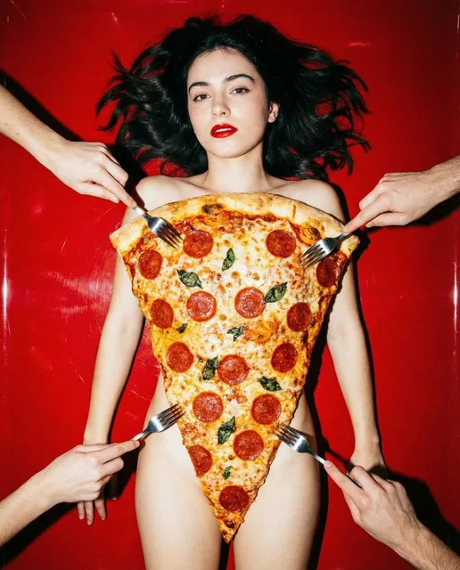 Top-down editorial photograph of an attractive young woman lying on a vivid red table, her body covered by a giant triangular slice of pepperoni pizza like a bikini. Multiple anonymous hands with forks pierce the pizza around her, creating a surreal and provocative fashion composition with high-cont