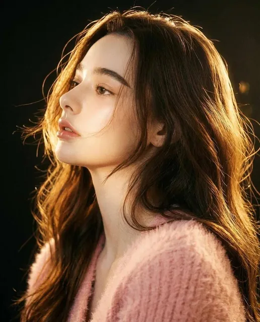 A cinematic portrait of a woman in side profile with golden hour lighting, featuring dramatic rim light, flawless skin, and a dreamy, ethereal atmosphere with visible film grain.