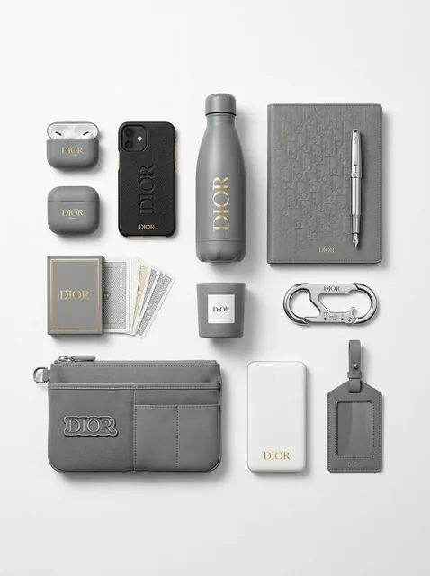 A curated set of premium branded merchandise, including tech accessories and lifestyle items, arranged neatly on a white background with soft shadows, showcasing the brand's signat