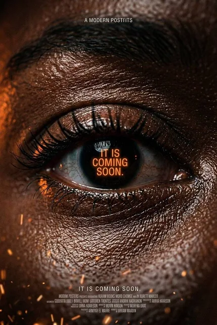 An extreme macro close-up of a human eye with deep rich brown skin texture, visible pores, and sharp eyelashes. Dramatic low-key lighting creates specular highlights and deep shadows, with glowing orange text reflected in the pupil against a dark void background.