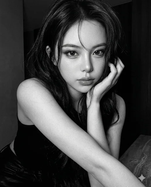 Hyper-realistic iPhone 17 Pro monochrome portrait of a young woman leaning forward with intense eye contact, arm near face, dramatic flash lighting, tight crop, deep shadows, and ultra-crisp skin details.