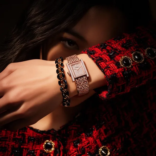 A close-up fashion editorial features a woman's arm crossed over her face, leaving a single dar...