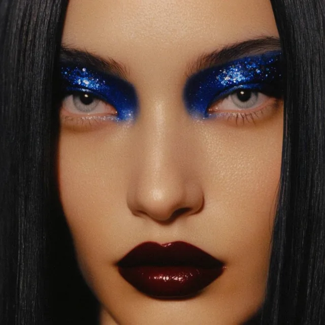 extreme close-up portrait of a woman with sharp angular features, piercing pale gray eyes, dire...
