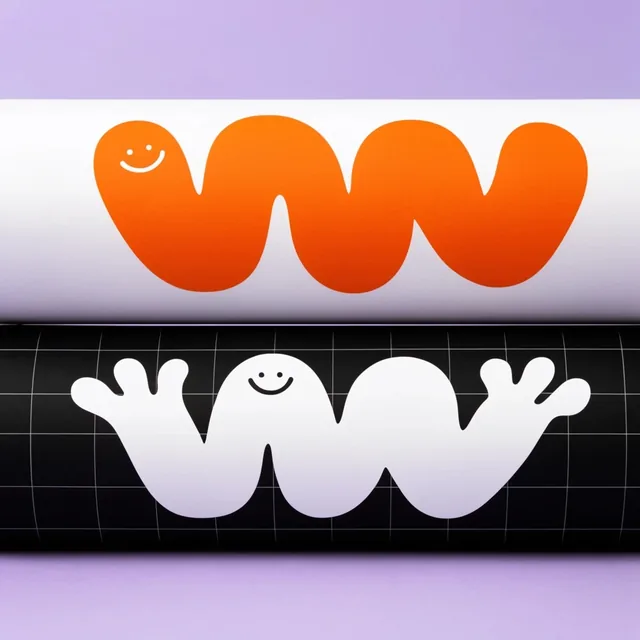Two horizontal cylindrical packaging tubes stacked against a seamless light purple background....