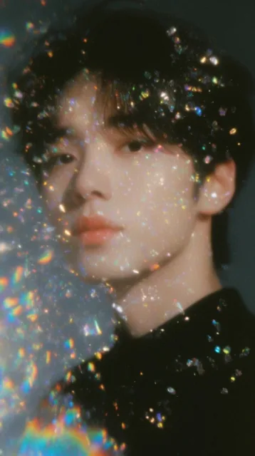 ethereal close-up portrait of a young man with dark hair and soft features, black top, heavily...
