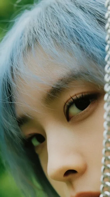 extreme close-up of a woman's eyes and nose, intense dark gaze, wispy light blue hair, fair ski...