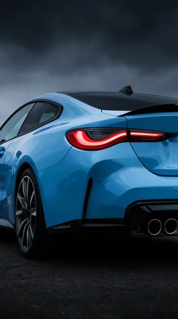 glossy light blue sports coupe, rear three-quarter view, glowing curved red taillights, black s...