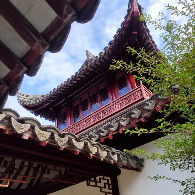 Sweeping curved rooflines and intricate wooden lattice define a traditional East Asian pavilion...