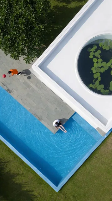 An aerial top-down view of a modern architectural landscape defined by sharp geometric intersec...