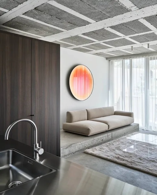 modern open interior, stainless steel sink and curved faucet, tall dark wood cabinetry, low-pro...