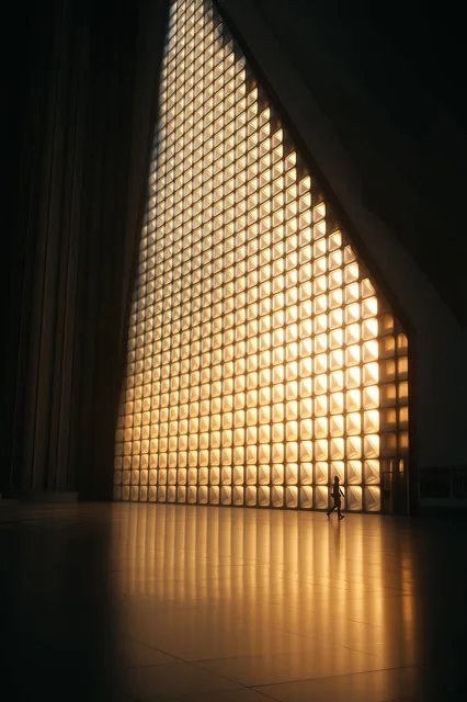 photography, triangular pattern translucent glass wall installation with black metal fram...