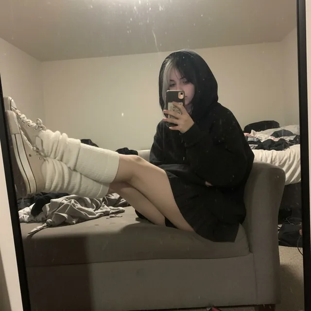 An extremely unremarkable iPhone mirror selfie photo with no clear subject or framing—jus...