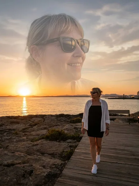 Cinematic double exposure portrait of a woman walking on a wooden path by the sea at sunset, with a semi-transparent smiling portrait overlaid, featuring warm golden hour lighting