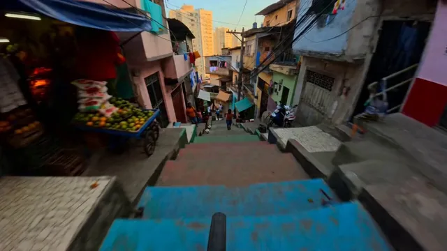 SUBJECTS: First-person cyclist, handlebars and front wheel flashing low in frame during drops and hard turns. Vendors, l