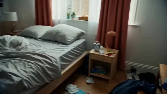 A sequence of scenes depicting a person's journey from their apartment through various travel points like a taxi, airport, airplane, and finally a hotel room, highlighting the mood