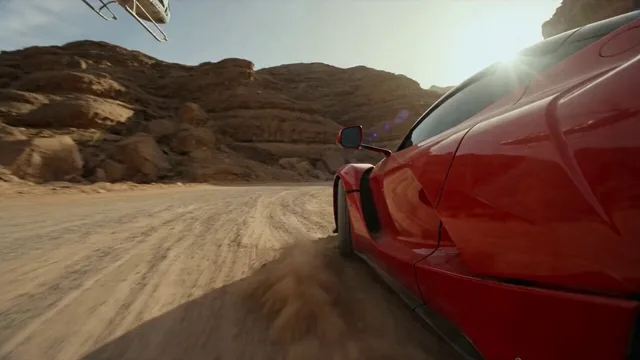 A hyper-realistic, high-octane cinematic video captures a red supercar drifting around a dirt corner in a sun-scorched r