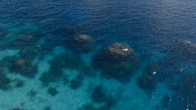 A hyper-realistic, high-cinematic aerial drone shot of a vintage yellow seaplane performing a high-speed, evasive dive-t