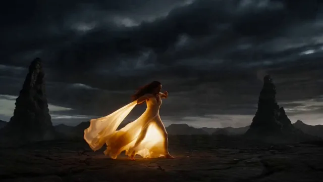 A high-stakes, 15-second cinematic sequence of a sorceress in a pale yellow silk gown performing a primal fire ritual on