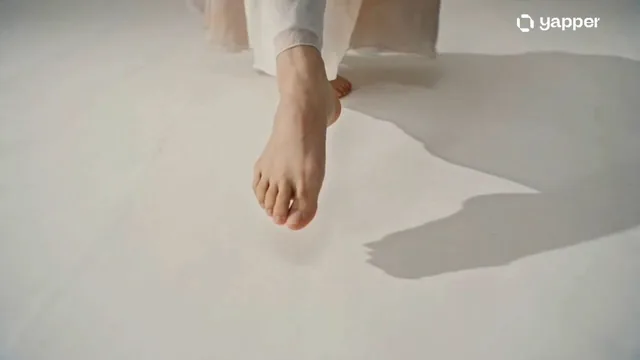 Create a 15-second cinematic video in an ink wash + watercolor painting style. A graceful dancer moves slowly in an empt