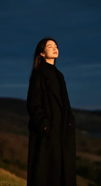 Woman walking gracefully in a breeze, cinematic shots, natural expression, detailed hair and fabric movement, peaceful moment.
