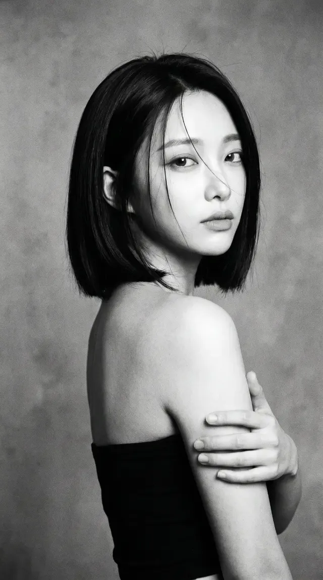 A black and white, grainy photograph that looks like an old film scan, capturing a candid indoor moment.