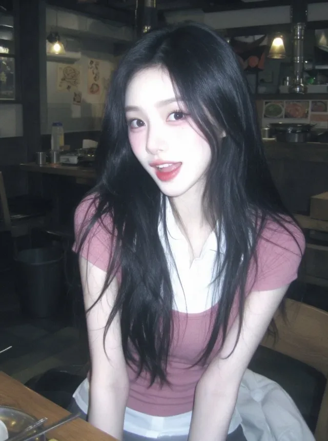 A young woman with long dark hair sitting at a wooden table in a Korean restaurant, styled with a retro DV camcorder look and nostalgic film grain.