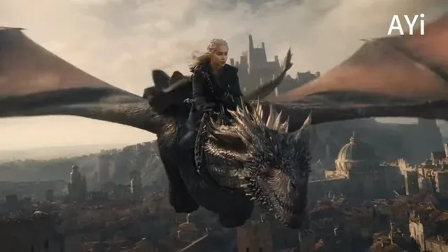 Drogon, the dragon, unleashes a torrent of fire while flying low and fast over the rooftops of King's Landing, with Daenerys on its back, in a dramatic, cinematic scene.