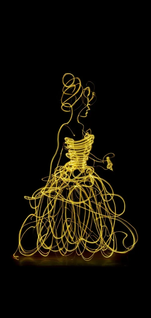 Silhouette of a woman in a golden light-painted gown against a black background, created using light painting technique.