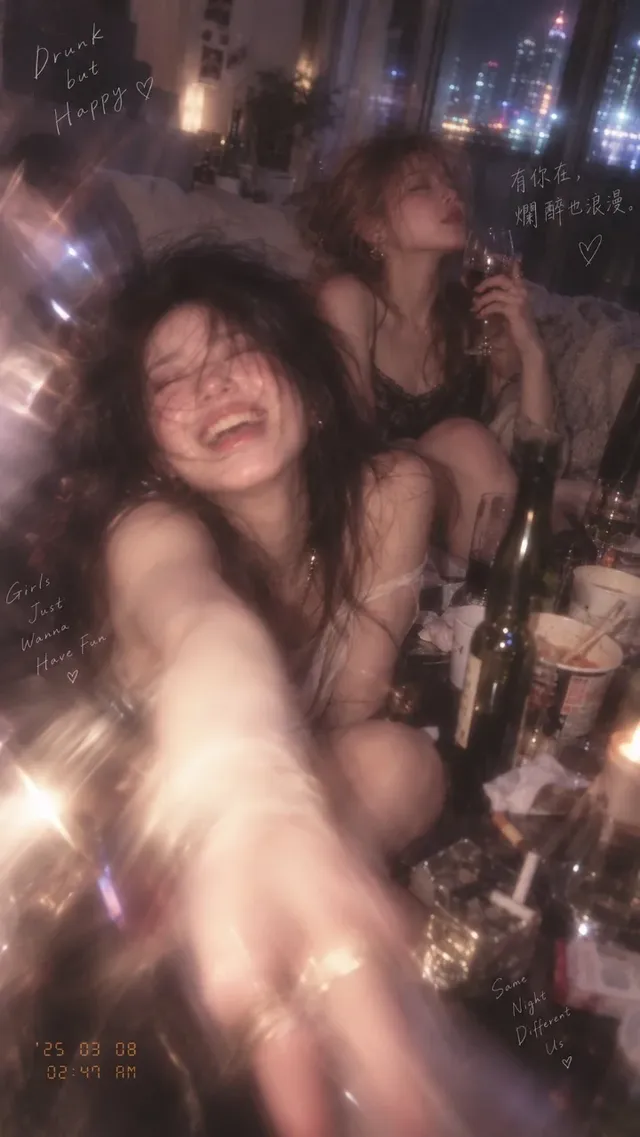 Photorealistic candid photo of two young East Asian women in a messy apartment afterparty, with heavy motion blur, light streaks, and a tipsy, intimate atmosphere. Close-up on one woman's hand and wine glass.